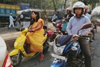 বাসন্তীর সাজে স্কুটি চালাচ্ছেন তরুণী,সোশ্যাল মিডিয়ায় ভাইরাল